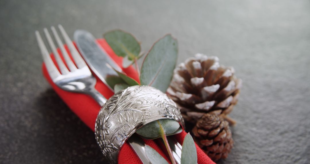 Holiday Table Setting with Silverware and Pine Cone on Festive Red Napkin - Free Images, Stock Photos and Pictures on Pikwizard.com