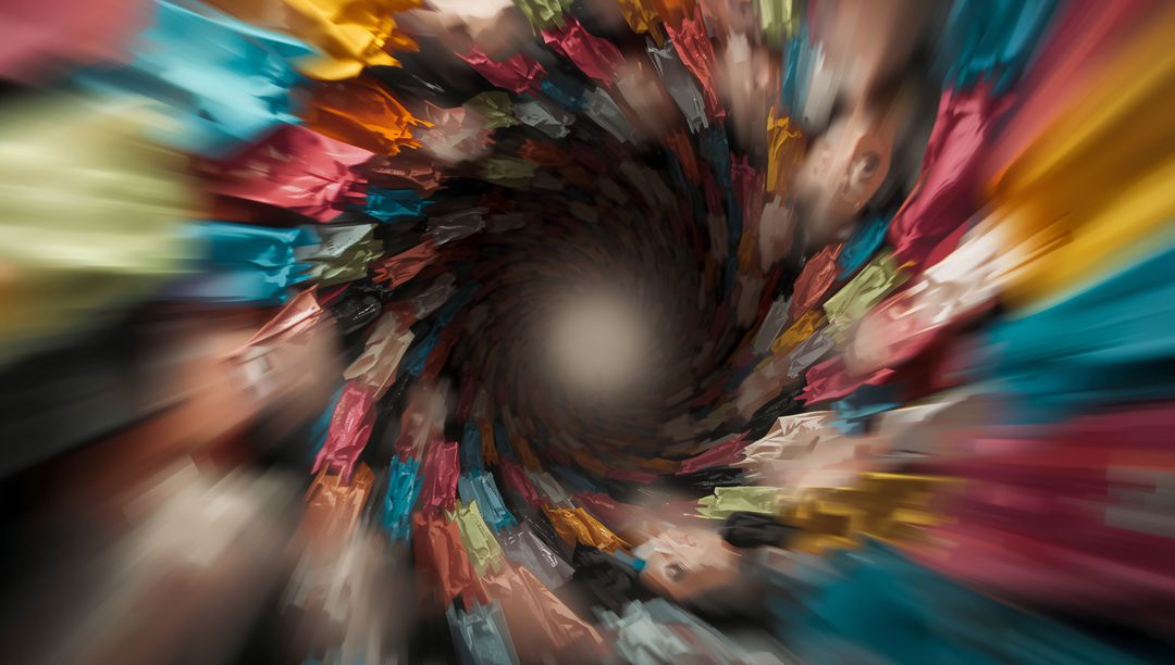Swirling Crowd Vortex Pulling Vibrant Clothing into Abstract Colorful Spiral Motion