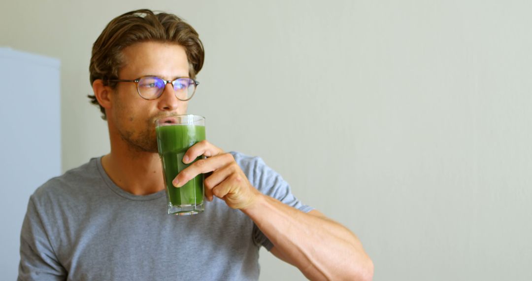 Man Drinking Healthy Green Smoothie in Casual Setting - Free Images, Stock Photos and Pictures on Pikwizard.com