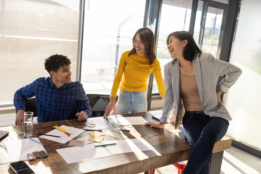 Creative Coworkers Collaborating at Workspace with Design Sketches