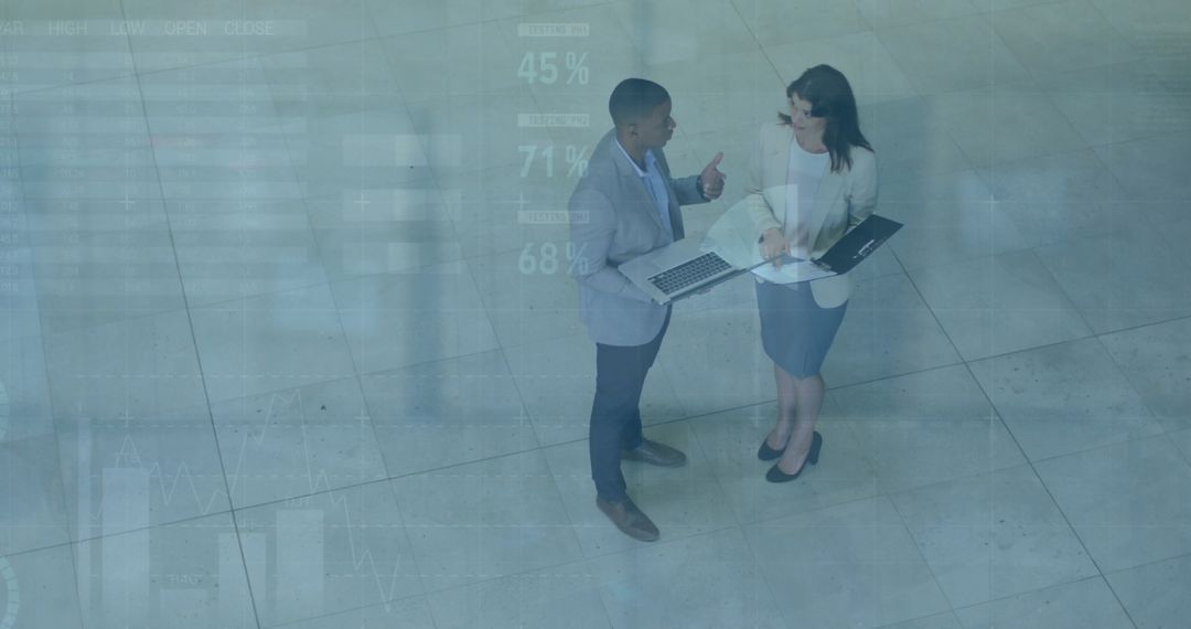 Business Professionals Discussing Strategies With Technology in Modern Office