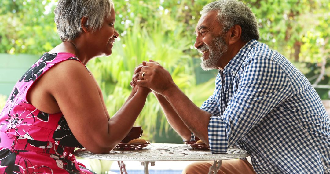 Smiling Senior Couple Sharing a Moment Over Coffee in Garden - Free Images, Stock Photos and Pictures on Pikwizard.com