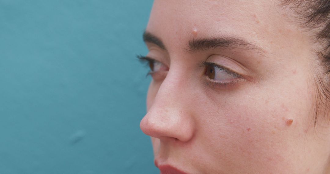 Close-up Portrait of Woman with Clear Skin Against Blue Background - Free Images, Stock Photos and Pictures on Pikwizard.com