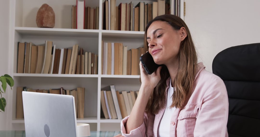 Woman Engaging in Phone Conversation in Modern Home Office