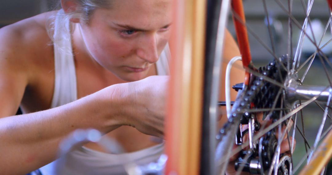 Focused Woman Fixing Bicycle Gear, Concentration and Skill - Free Images, Stock Photos and Pictures on Pikwizard.com