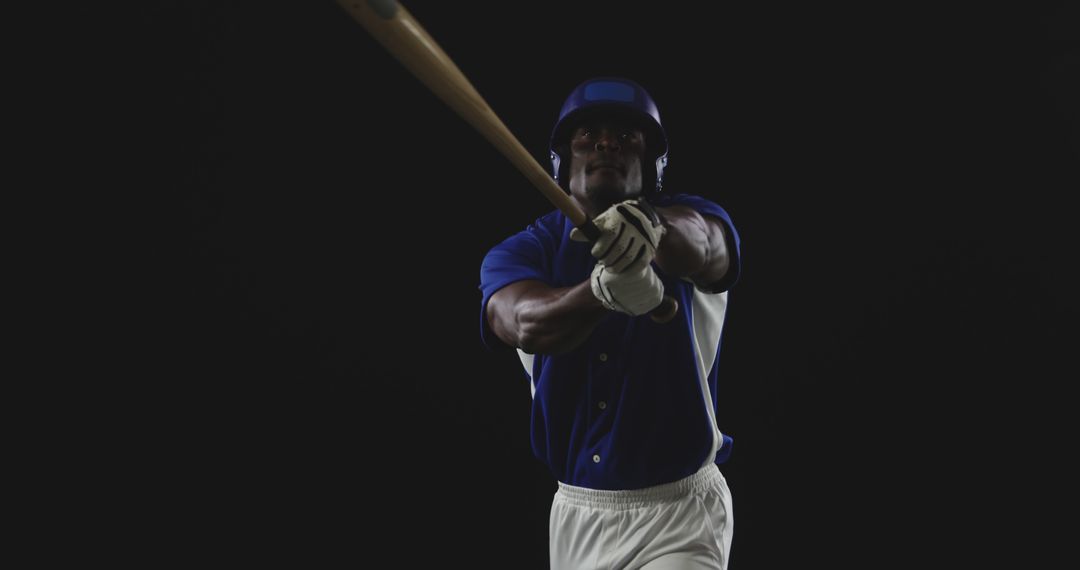 Professional Baseball Player Swinging Bat on Dark Background - Free Images, Stock Photos and Pictures on Pikwizard.com