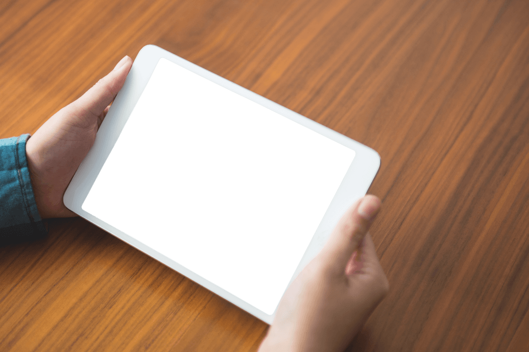 Hands Holding Transparent Digital Tablet on Wooden Tabletop