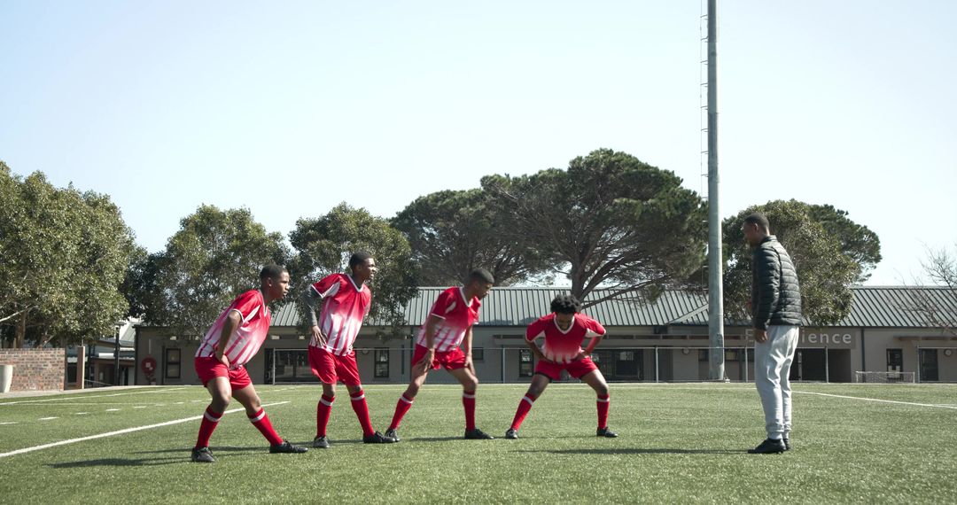 Soccer Team Warming Up With Coach Offering Guidance on Field