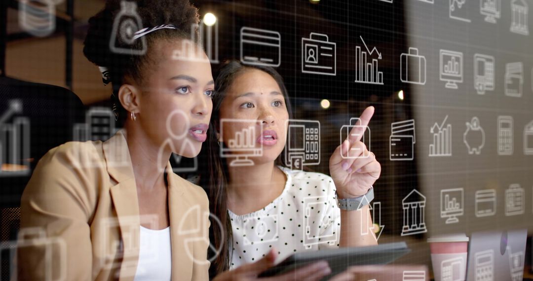 Diverse Businesswomen Analyzing Virtual Data on Screen