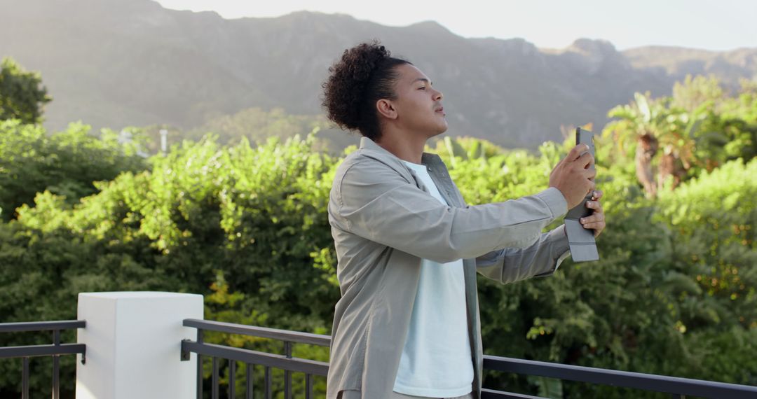 Man Relaxing on Balcony Amidst Scenic Mountain Landscape