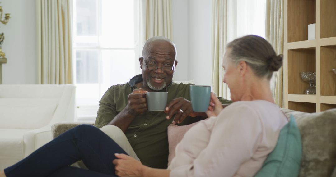 Smiling Senior Couple Enjoying Coffee Together at Home - Free Images, Stock Photos and Pictures on Pikwizard.com