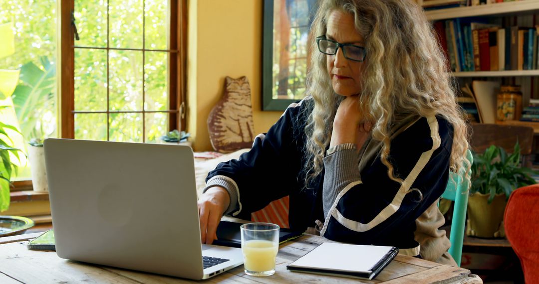 Middle-Aged Woman Working Remotely from Home with Laptop - Free Images, Stock Photos and Pictures on Pikwizard.com