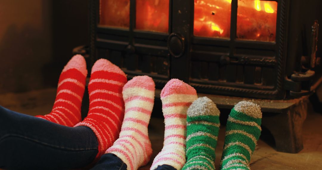 Family Relaxing in Colorful Striped Socks by Cozy Fireplace