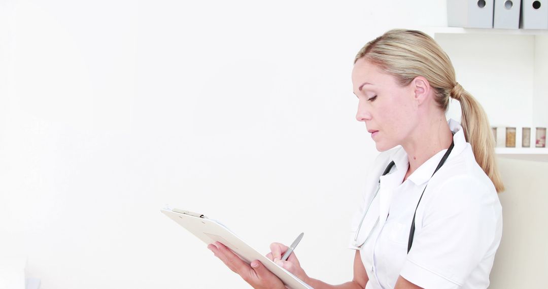 Female Doctor Taking Notes on Clipboard in Clinic - Free Images, Stock Photos and Pictures on Pikwizard.com