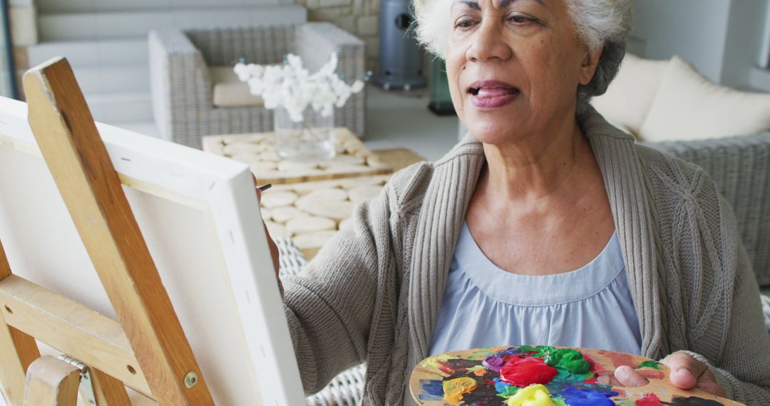 Senior Woman Painting on Canvas Indoors - Free Images, Stock Photos and Pictures on Pikwizard.com