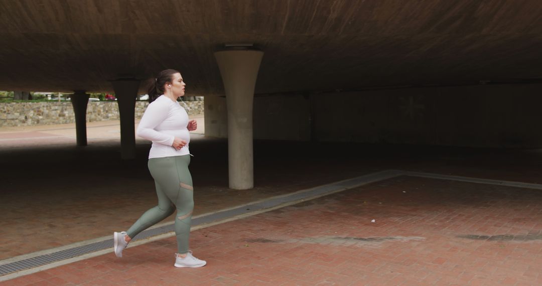 Woman Running Under Urban Overpass in Activewear - Free Images, Stock Photos and Pictures on Pikwizard.com