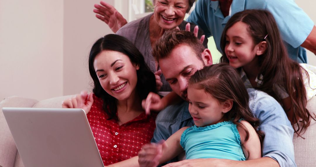 Happy Multigenerational Family Using Laptop on Couch - Free Images, Stock Photos and Pictures on Pikwizard.com