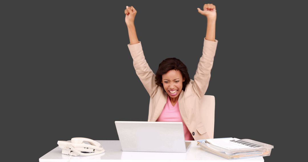 Excited Businesswoman Celebrating Success at Work Desk - Free Images, Stock Photos and Pictures on Pikwizard.com