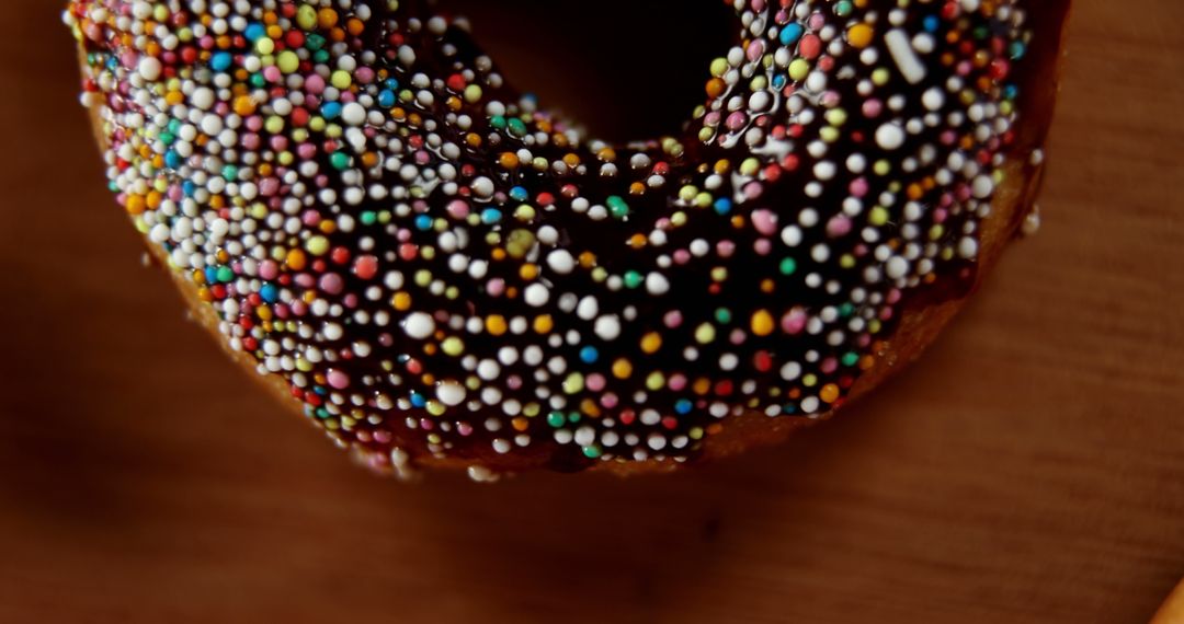 Close up of donut with hundreds of thousands sprinkle with copy space - Free Images, Stock Photos and Pictures on Pikwizard.com
