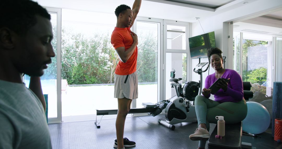 Home Exercise with Kettlebell and Tablet in Bright Home Gym