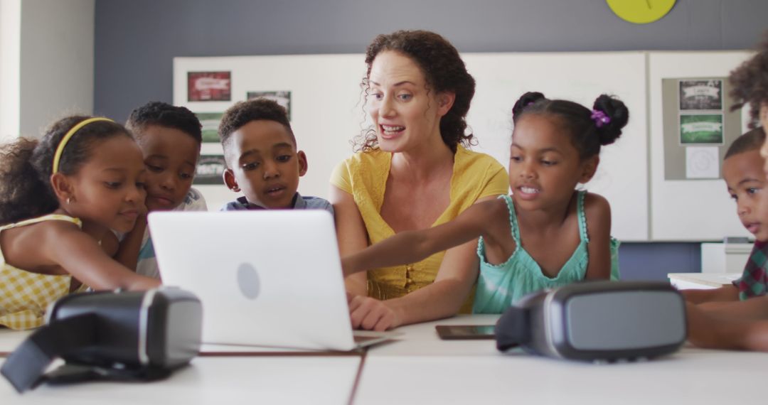 Teacher Engaging with Diverse Group of Children Using Laptop and Virtual Reality - Free Images, Stock Photos and Pictures on Pikwizard.com