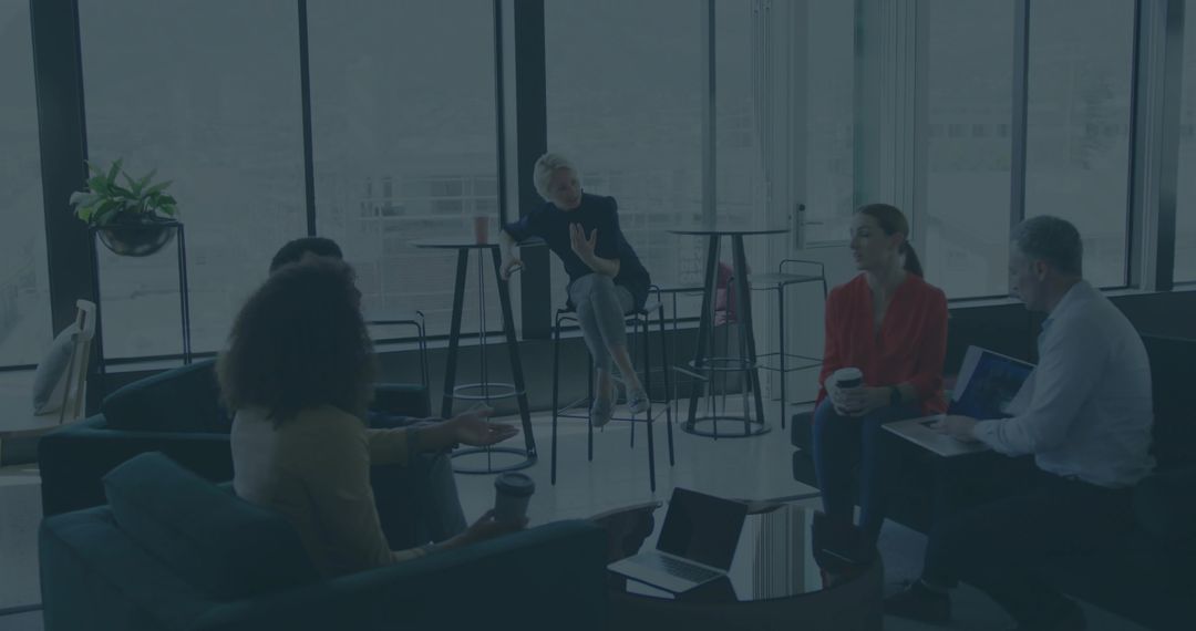 Coworkers Engaged in Collaborative Meeting in Modern Office Lounge