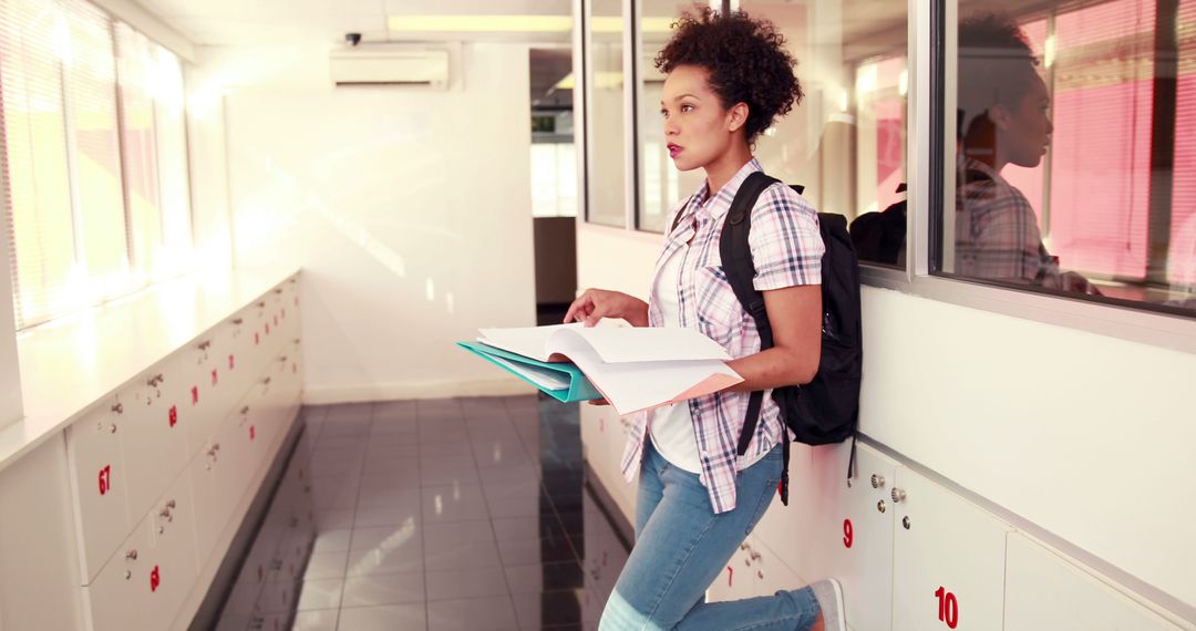 Female Student Reading Book in College Hallway - Free Images, Stock Photos and Pictures on Pikwizard.com