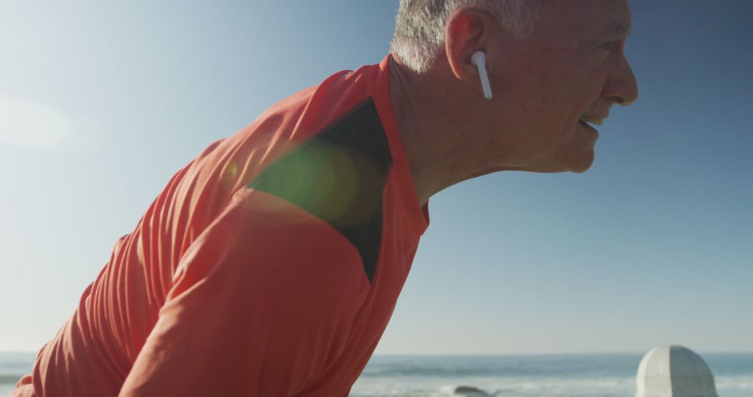 Senior Man Exercising Outdoors with Wireless Earbuds on Sunny Day - Free Images, Stock Photos and Pictures on Pikwizard.com