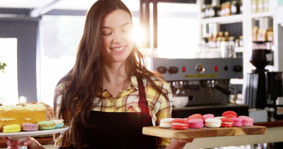 Happy Woman Holding Tray of Colorful Macarons in Coffee Shop - Free Images, Stock Photos and Pictures on Pikwizard.com