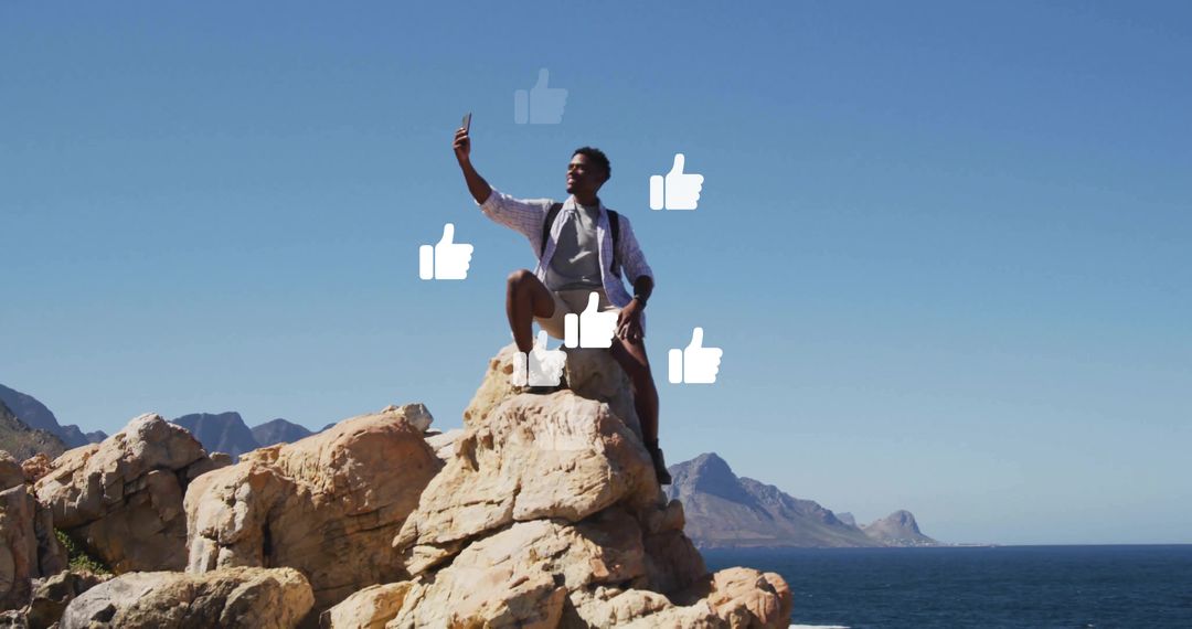 Hiker Taking Selfie on Cliff With Thumbs-Up Icons Overlooking Ocean