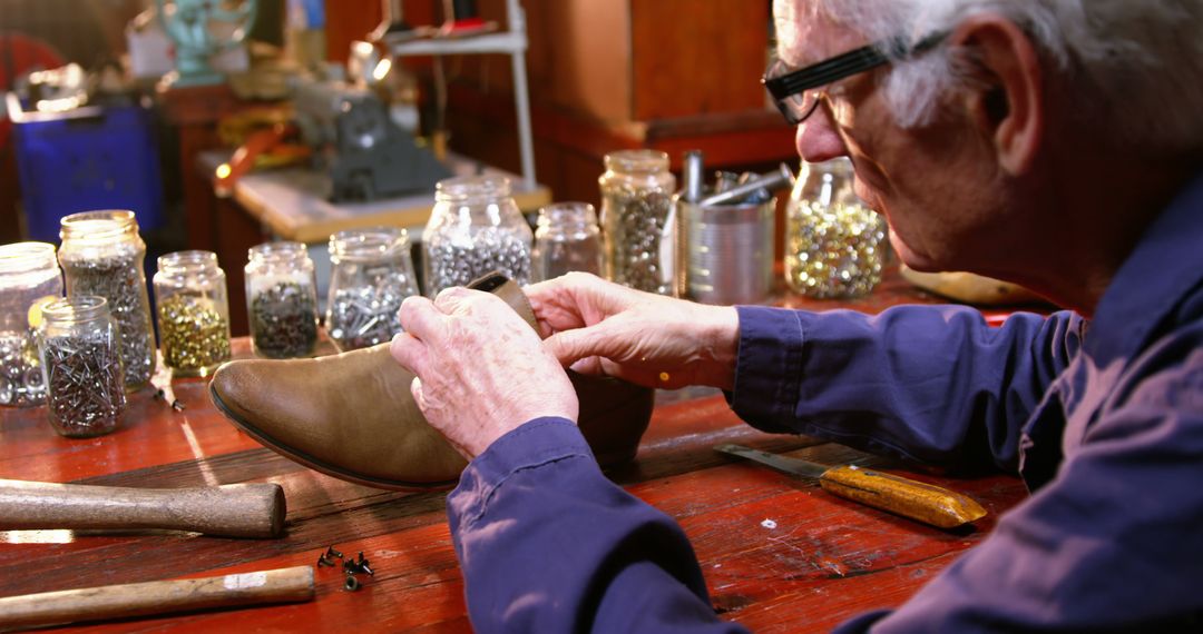 Shoemaker examining a shoe in workshop 4k - Free Images, Stock Photos and Pictures on Pikwizard.com