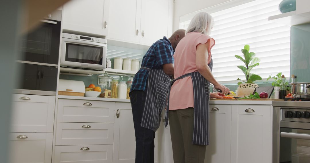 Senior Couple Preparing Meals in Modern Kitchen - Free Images, Stock Photos and Pictures on Pikwizard.com