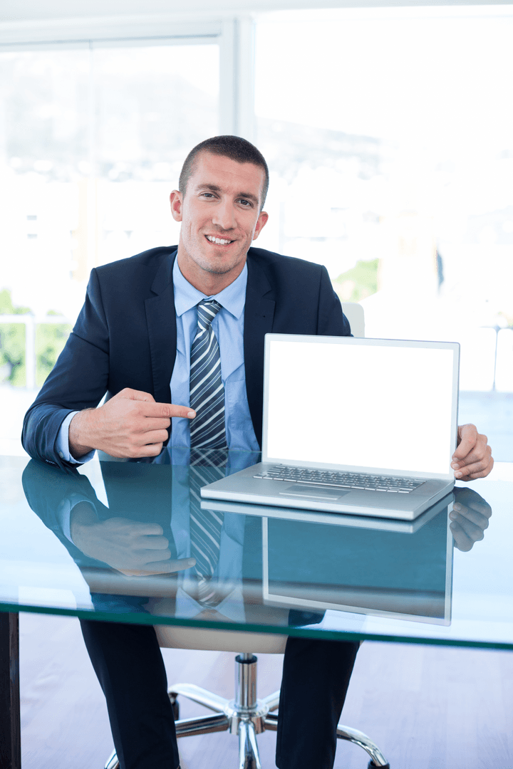 Transparent Businessman Pointing at Blank Laptop Screen in Office