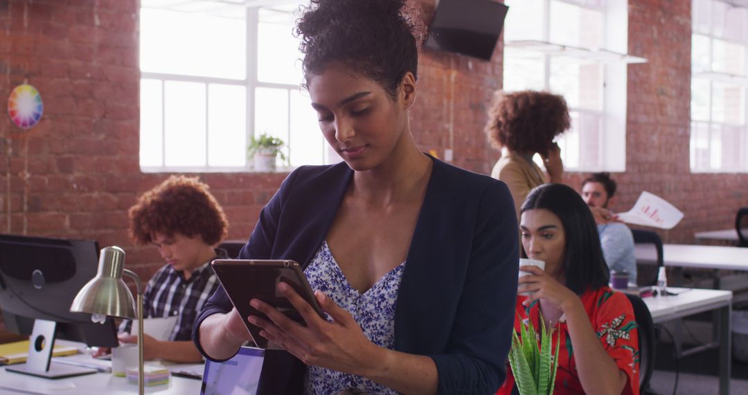 Professional Woman Using Tablet in Creative Office Environment