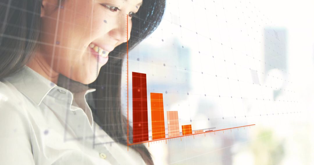 Asian Professional Analyzing Bar Chart for Business Insights