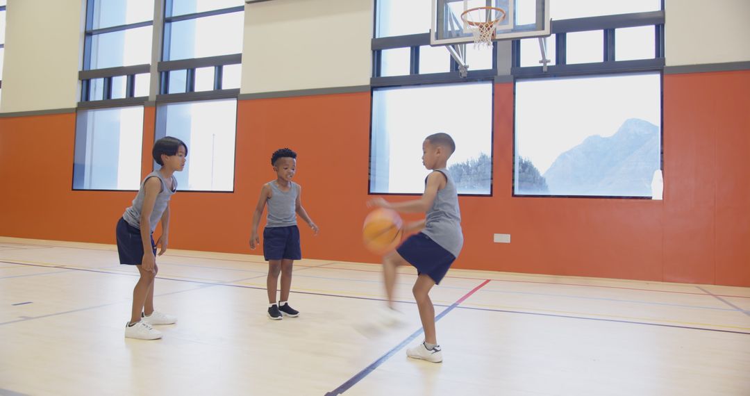 Boys Passing Basketball in School Gym During Playtime