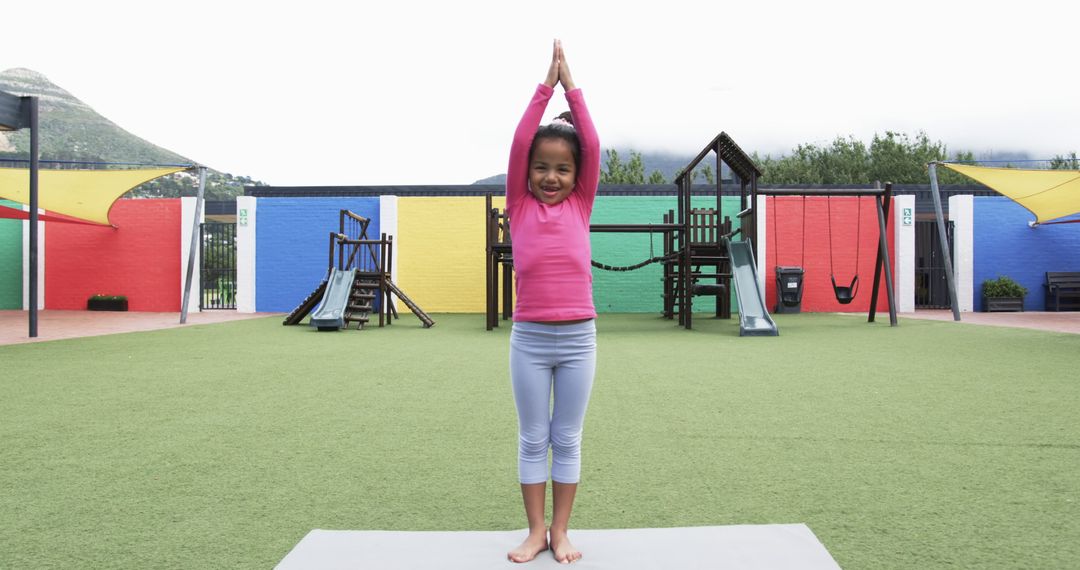 Child Practicing Yoga in Colorful School Playground
