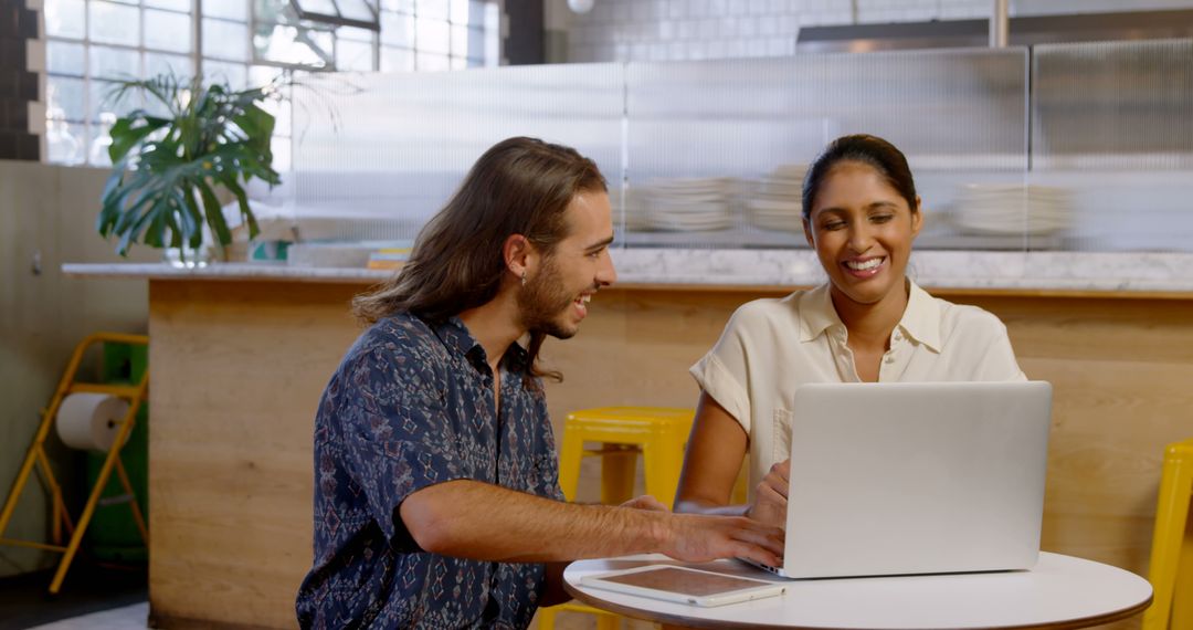 Diverse Professionals Collaborating in Sunlit Cafe Workspace