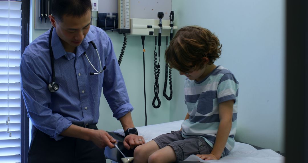 Pediatrician Examining Young Patient's Knee in a Clinic - Free Images, Stock Photos and Pictures on Pikwizard.com