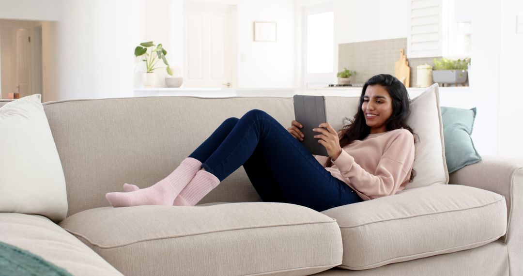 Relaxed Woman Using Tablet in Cozy Living Room Setting