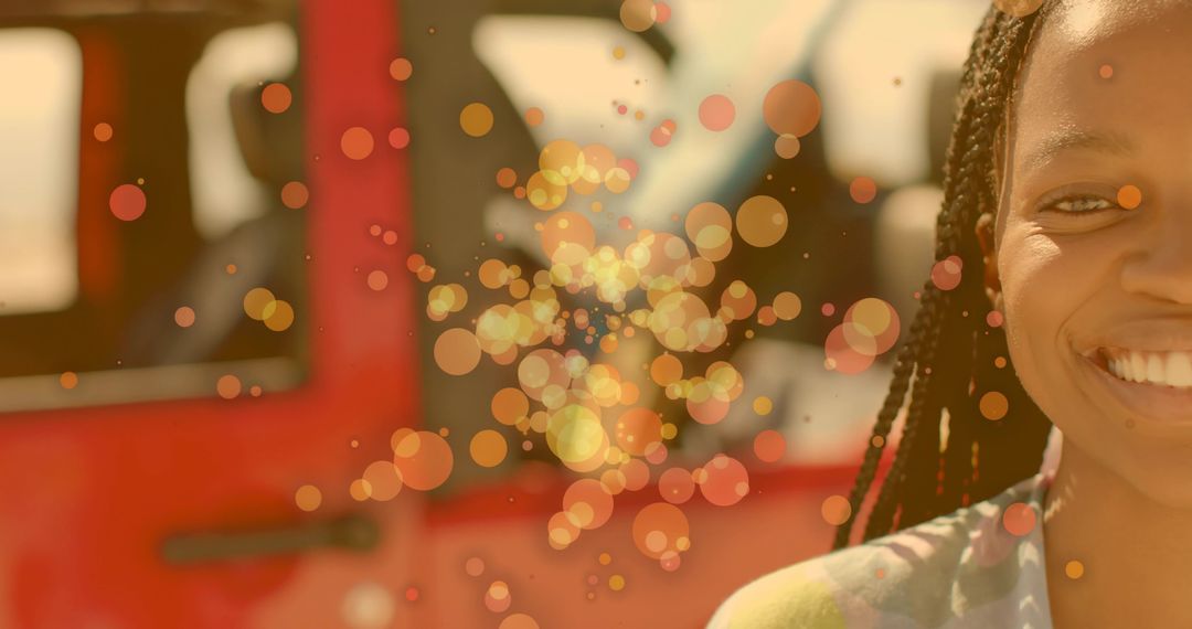 Joyful Woman Smiling Near Red SUV with Sunny Bokeh Effect