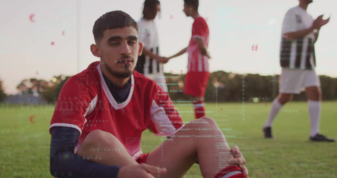 Resilient Soccer Player in Red Jersey Sitting on Field After Game