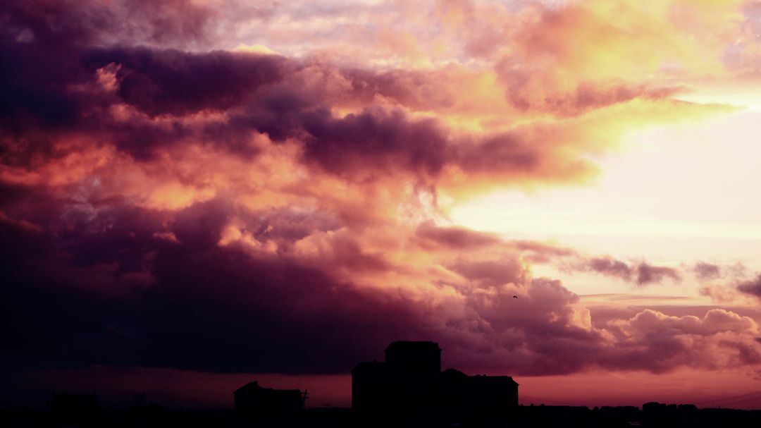Dramatic Sunset with Silhouetted Cityscape - Free Images, Stock Photos and Pictures on Pikwizard.com