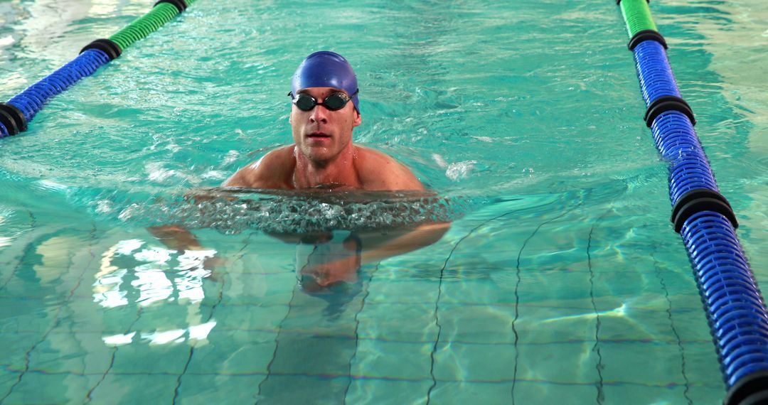 Male Swimmer Wearing Swim Cap and Goggles in Indoor Swimming Pool - Free Images, Stock Photos and Pictures on Pikwizard.com