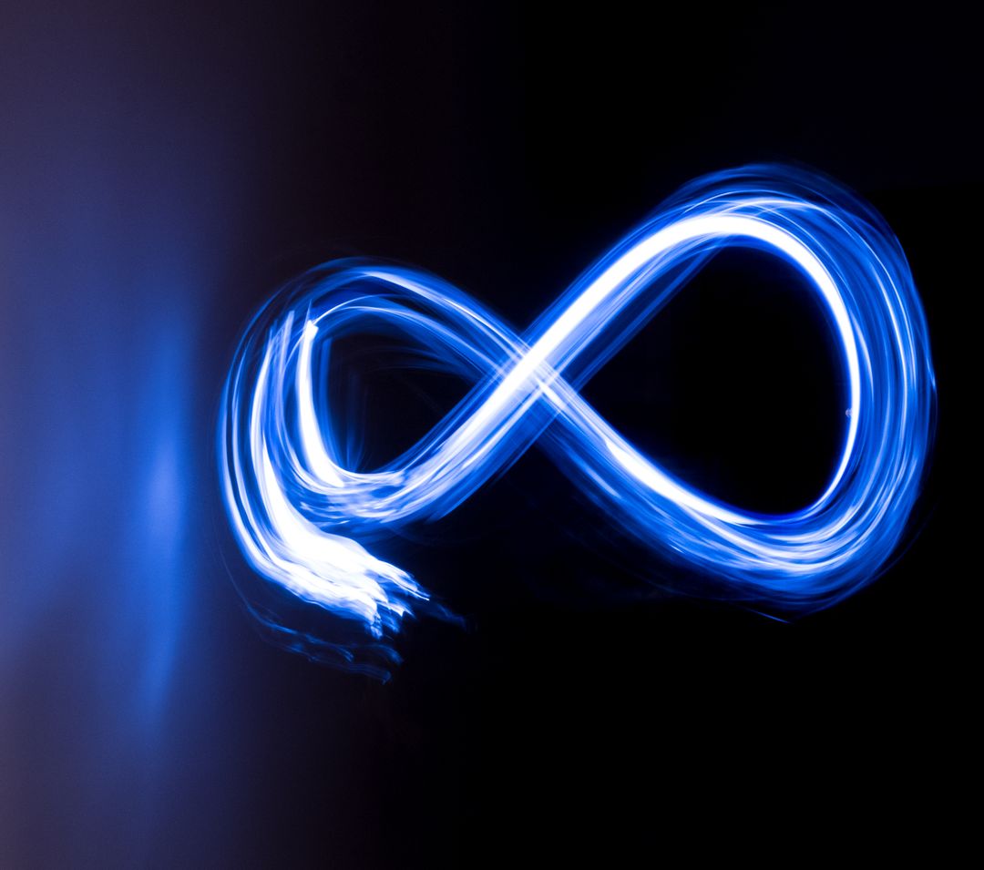 Glowing Infinity Symbol in Blue Light Painting on Black Background - Free Images, Stock Photos and Pictures on Pikwizard.com