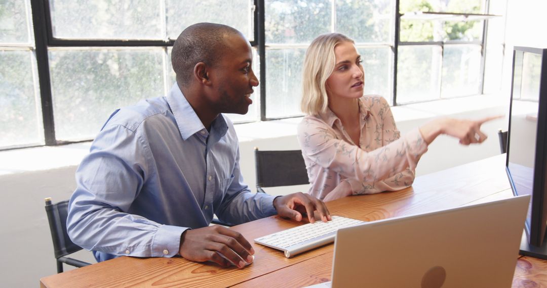 Multiracial Team Collaborating on Project at Modern Office