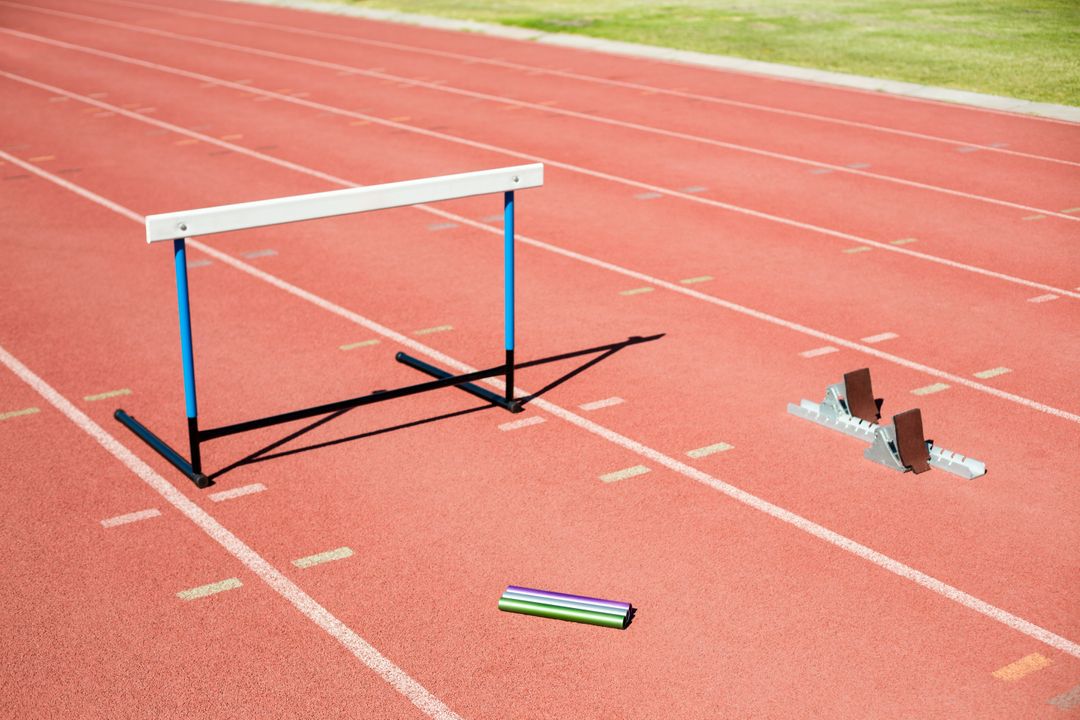 Hurdle, Relay Baton, and Starting Block on Running Track - Free Images, Stock Photos and Pictures on Pikwizard.com