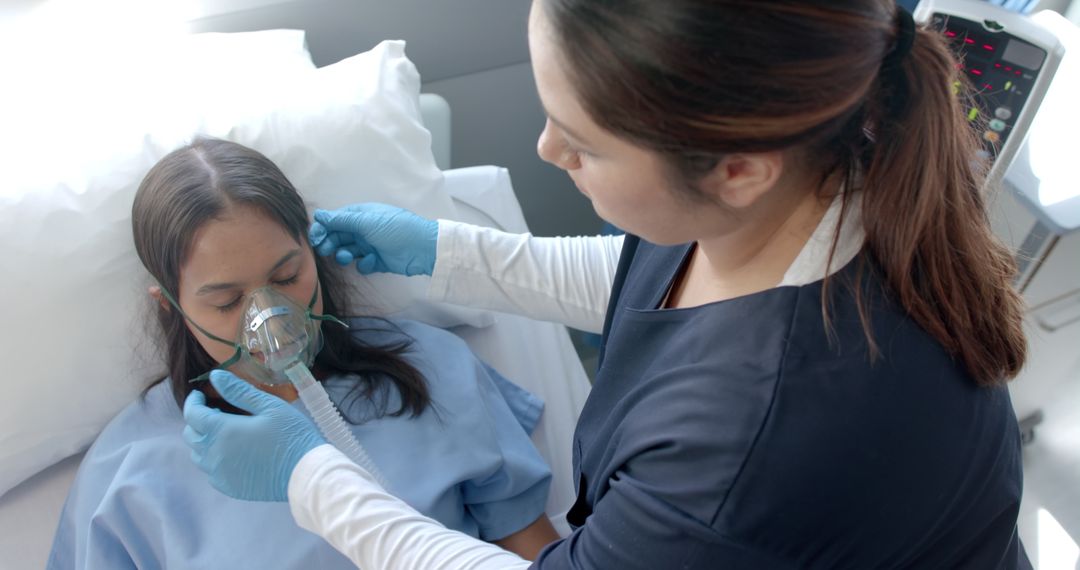 Nurse Caring for Patient with Oxygen Mask in Hospital