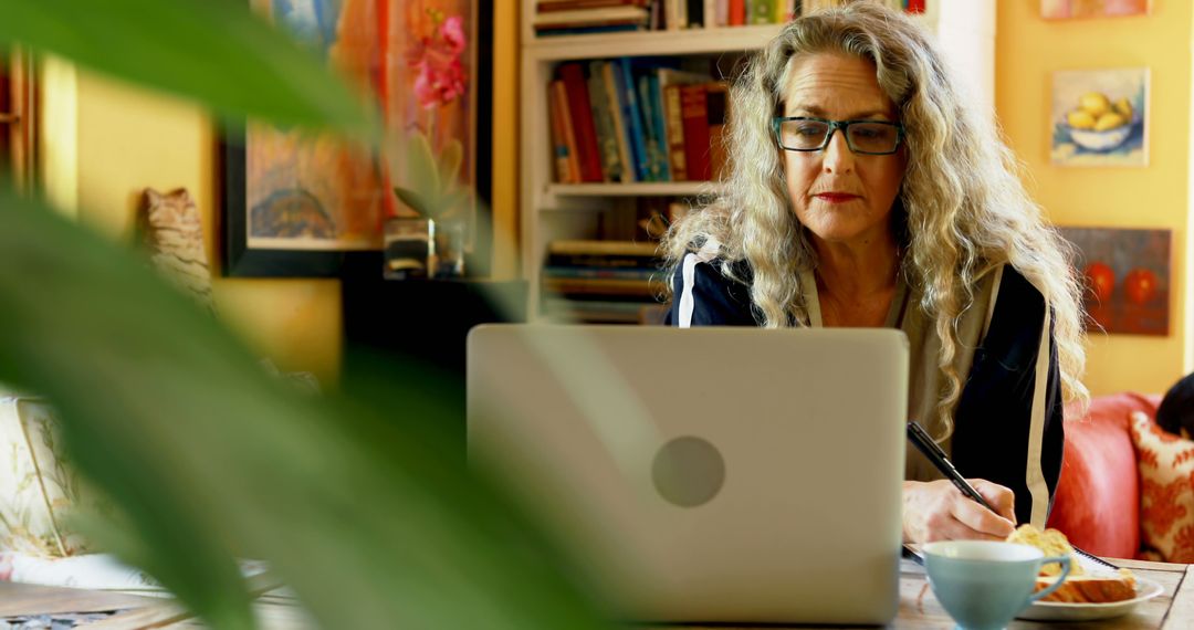 Mature Woman Working on Laptop in Cozy Home Office - Free Images, Stock Photos and Pictures on Pikwizard.com