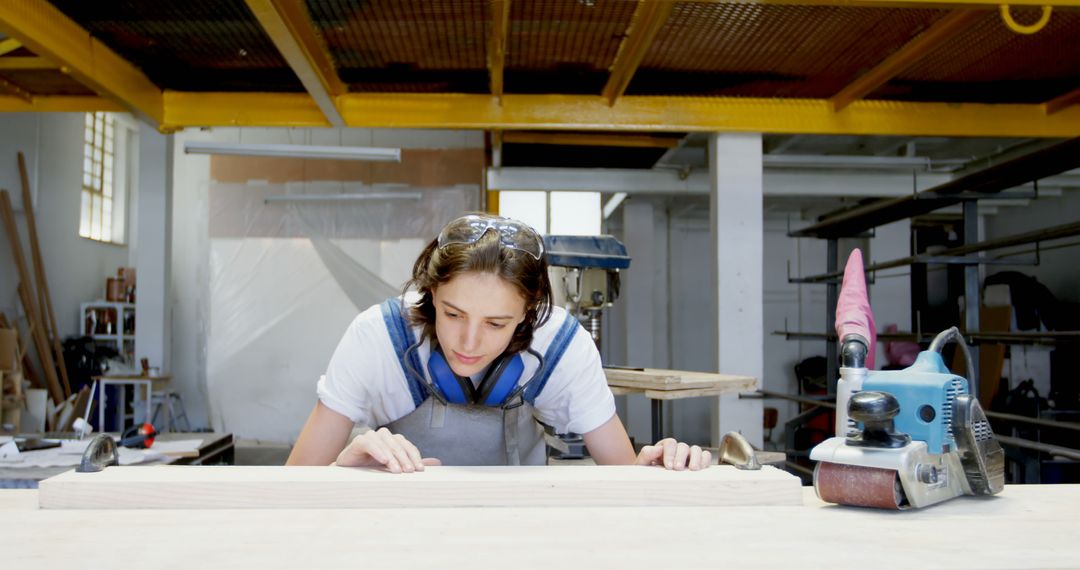 Young Female Carpenter Creating Precise Woodwork in Workshop - Free Images, Stock Photos and Pictures on Pikwizard.com